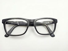 Tommy Hilfiger Glasses on wooden surface